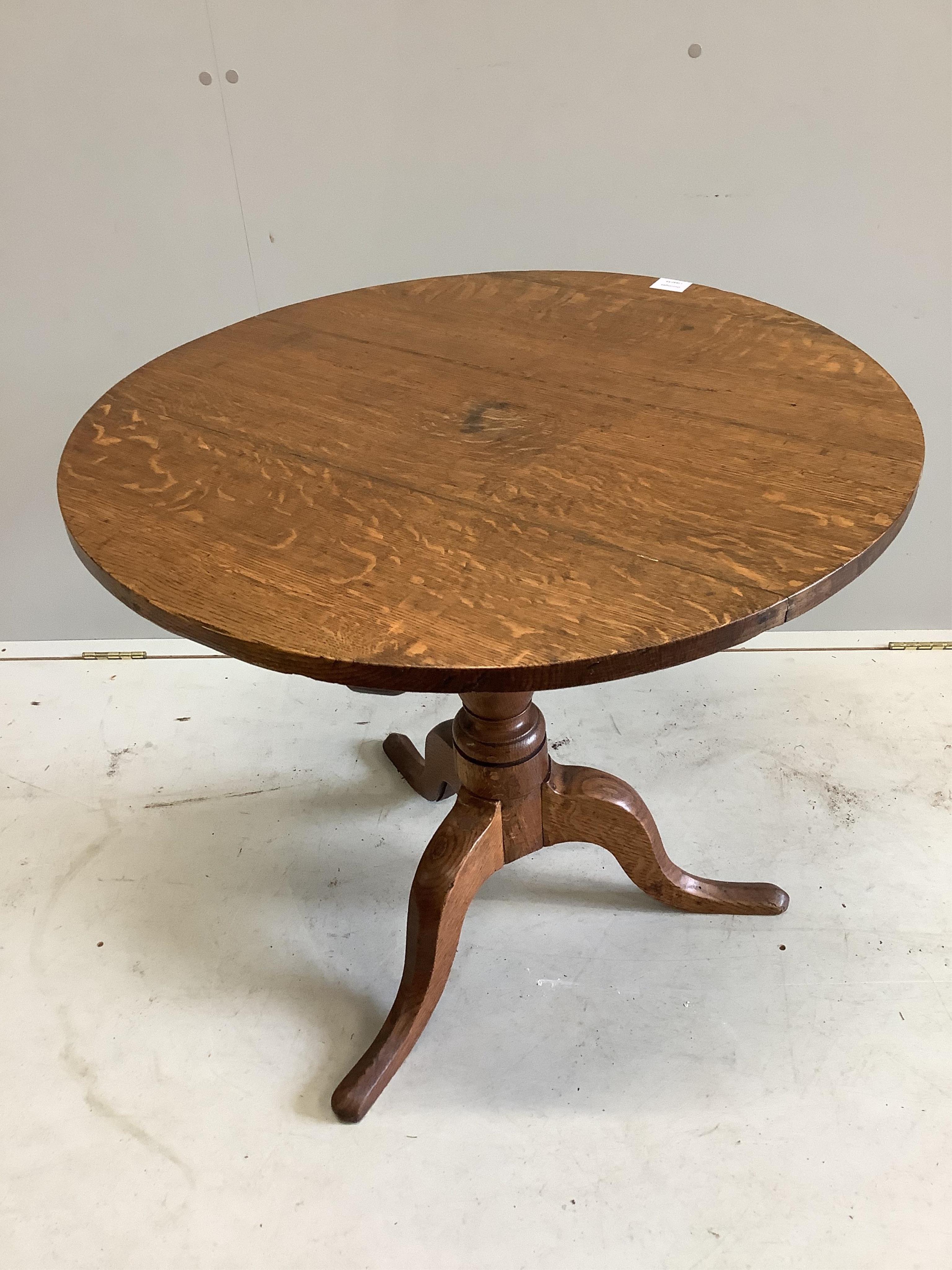 A George III oak tripod table, diameter 78cm, height 71cm. Condition - fair to good